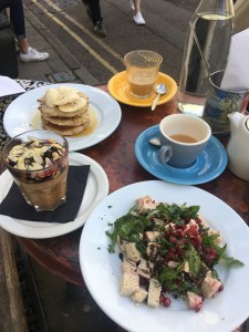 Table laid for brunch and filled with food and drinks