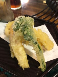 pile of tempura vegetables with tenderstem broccoli on top