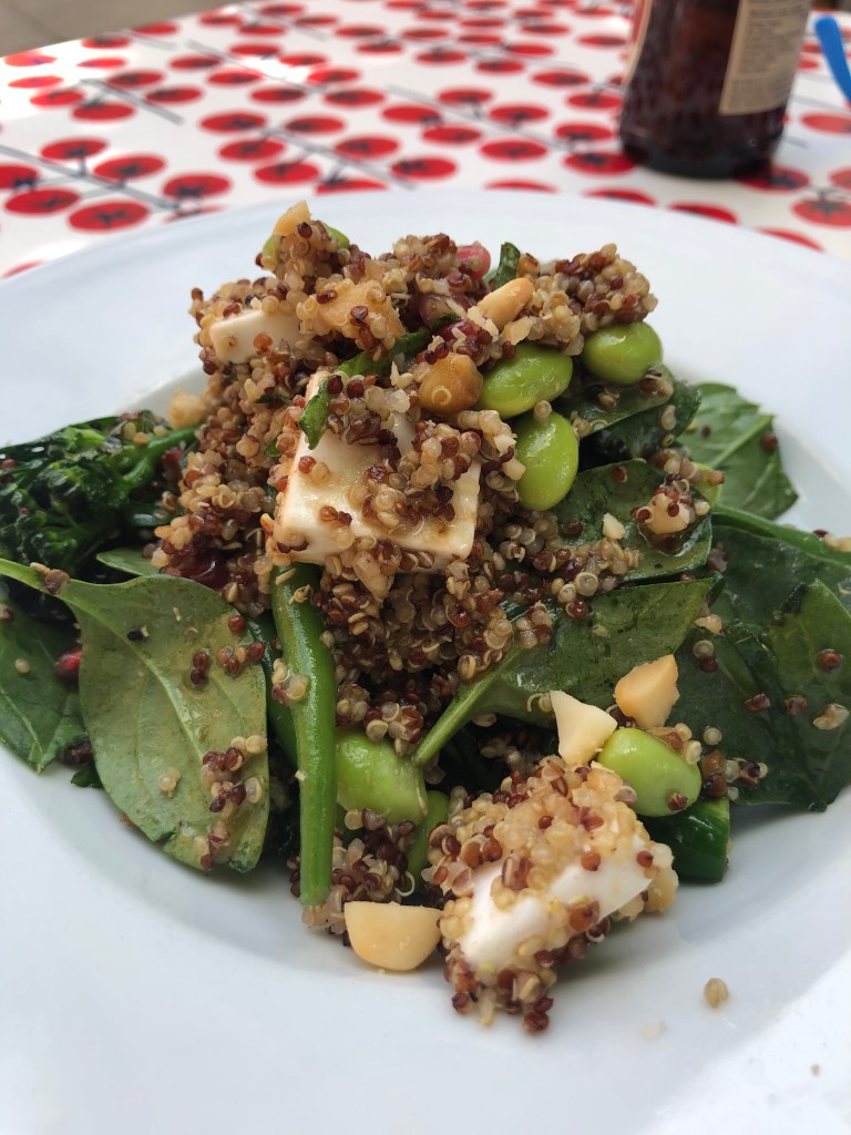 mixed quinoa salad with green vegetables, spinach and vegan feta cheese
