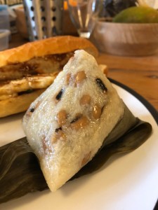 shiny white pyramid of rice with black eyed beans dispersed unevenly throughout