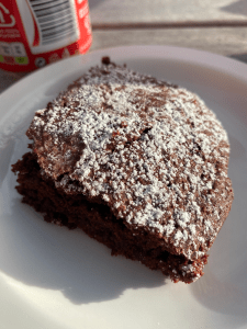 corner piece of brownie with heavy dusting of icing sugar on top