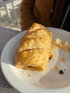 white side plate with small sausage roll pastry on