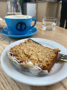 Slice of brown sponge cake with white icing on top